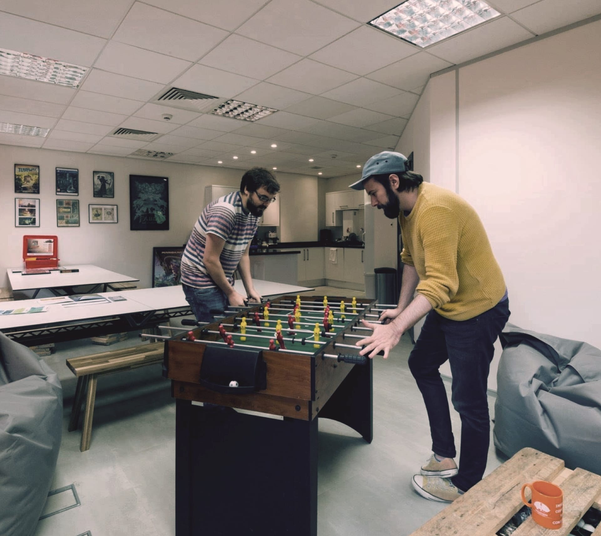 Vector Suite employees playing Foozball in the office